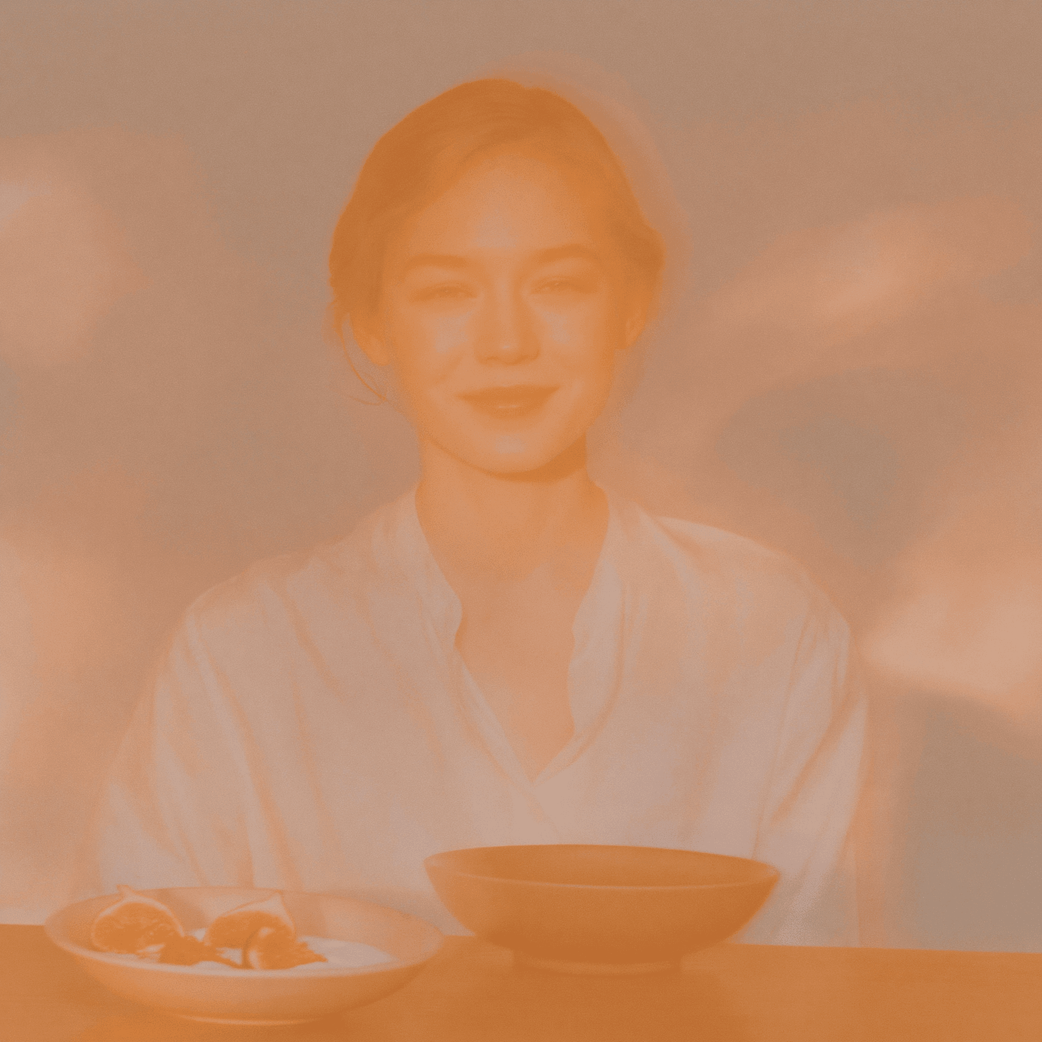 A woman in cream linen at a sunlit oak table, evoking the considered, complete picture the Complete GI Bundle delivers