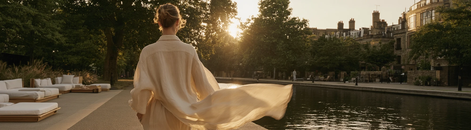 A woman walking along a London canal at golden hour